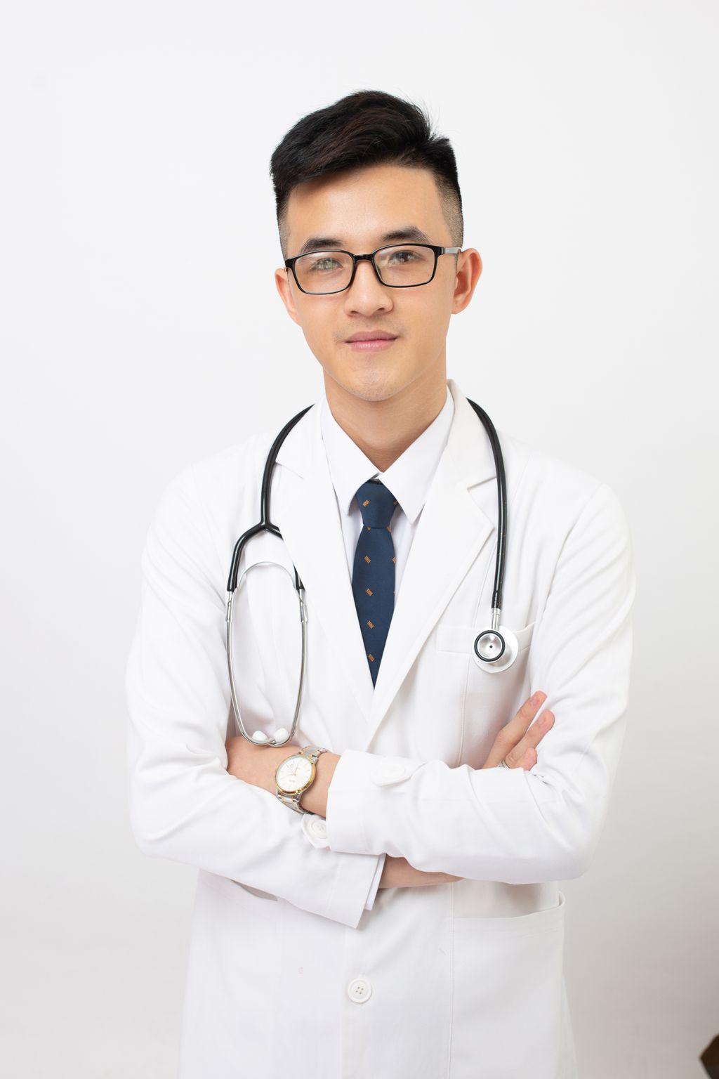 Portrait of a confident young doctor wearing a stethoscope and eyeglasses, exuding professionalism.